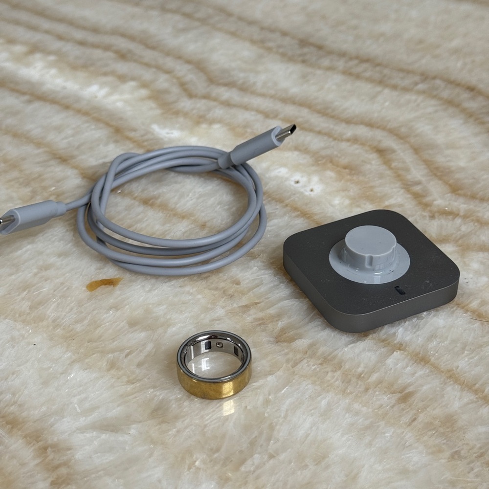 Gold Oura Ring 4 Smart Ring with charging dock